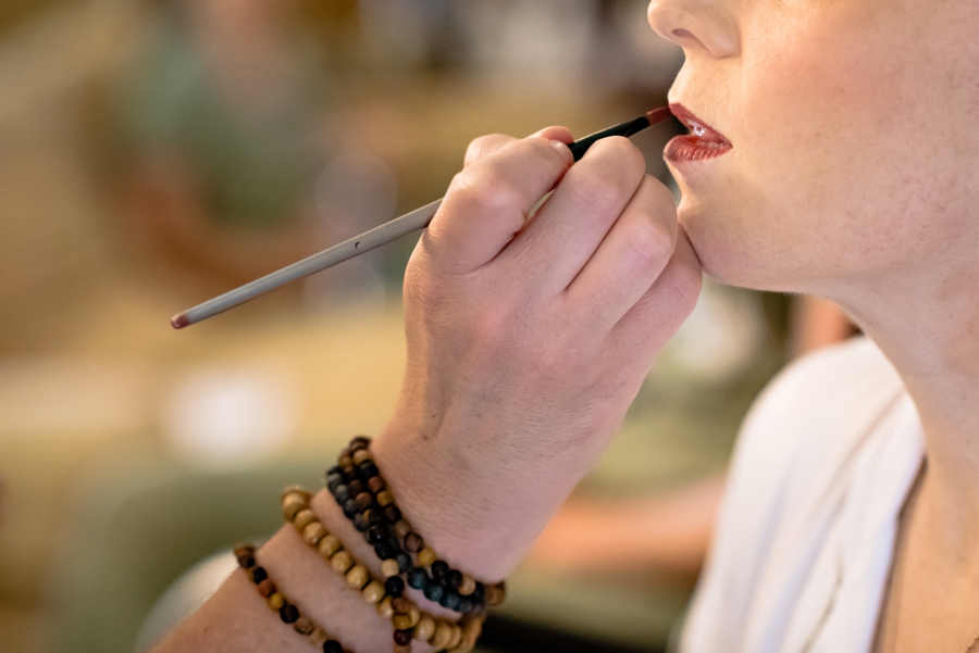 Finishing touches on a brides lipstick.